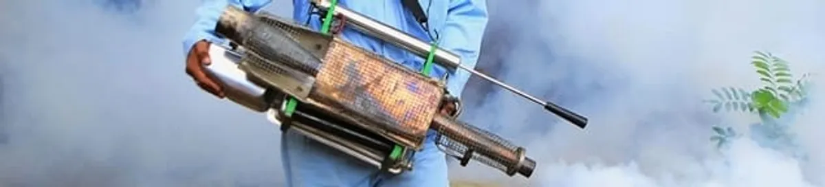 Fumigation technician using a fogger for deep pest treatment in Ogden, UT